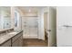 Bright bathroom featuring a granite vanity top and tub with shower at 2231 Crosswind St, Fort Lupton, CO 80621