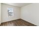 Bedroom with laminate flooring, white walls, and natural light at 2231 Crosswind St, Fort Lupton, CO 80621