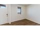 Bright entryway featuring wood-look flooring, a white front door, and a window with natural light at 2231 Crosswind St, Fort Lupton, CO 80621