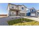 Well-maintained two-story home with neutral siding, a covered porch, and a two-car garage at 2231 Crosswind St, Fort Lupton, CO 80621