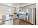 Modern kitchen featuring stainless steel appliances, grey cabinets, and granite countertops at 2231 Crosswind St, Fort Lupton, CO 80621