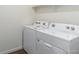 A utility room with a side by side, white washing machine and dryer at 2231 Crosswind St, Fort Lupton, CO 80621
