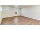 Spacious living room with laminate wood flooring and plenty of natural light at 2231 Crosswind St, Fort Lupton, CO 80621