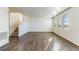 Spacious living area with stairs, wood-look floors and large windows providing natural light at 2231 Crosswind St, Fort Lupton, CO 80621