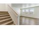 Bright living room with light-colored floors and lots of natural light from the many windows at 2231 Crosswind St, Fort Lupton, CO 80621