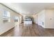 Open-concept living area with wood-look floors, and a modern kitchen with stainless steel appliances at 2231 Crosswind St, Fort Lupton, CO 80621