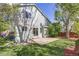 Backyard with well-maintained lawn and mature trees, offering a serene outdoor space for leisure and enjoyment at 11223 Jansen St, Parker, CO 80134
