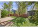 Spacious backyard featuring lush lawn, a wooden fence, and mature trees for privacy and outdoor enjoyment at 11223 Jansen St, Parker, CO 80134