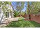 Large, level backyard with grass, mature trees, a patio, and a privacy fence, perfect for outdoor entertaining at 11223 Jansen St, Parker, CO 80134