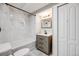 Well-lit bathroom featuring a shower/tub combo with marble tiles and modern vanity at 11223 Jansen St, Parker, CO 80134