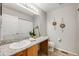 Functional bathroom featuring a granite countertop, oak cabinets, and a framed mirror at 11223 Jansen St, Parker, CO 80134