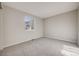 Spare bedroom featuring neutral tones, plush carpeting, and natural light at 11223 Jansen St, Parker, CO 80134