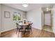 Cozy dining area featuring a round table, modern chairs, and natural light from the adjacent window at 11223 Jansen St, Parker, CO 80134