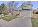 Well-maintained two-story home featuring an attached two-car garage and a manicured lawn at 11223 Jansen St, Parker, CO 80134