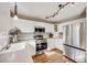Well-lit kitchen with stainless steel appliances, ample counter space, and modern lighting at 11223 Jansen St, Parker, CO 80134