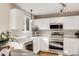 Bright, all-white kitchen with stainless steel appliances and natural light at 11223 Jansen St, Parker, CO 80134