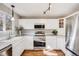 Bright, efficient kitchen with updated stainless steel appliances and modern white cabinets at 11223 Jansen St, Parker, CO 80134