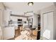 Eat-in kitchen featuring white cabinets, stainless steel appliances, and a round breakfast table at 11223 Jansen St, Parker, CO 80134