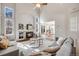 Bright living room features high ceilings, a stone fireplace, and views into the modern kitchen at 11223 Jansen St, Parker, CO 80134