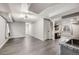 Open living room with gray floors, recessed lighting, and a partial kitchen view at 11223 Jansen St, Parker, CO 80134