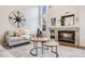 Cozy living room with a stone fireplace, comfortable seating, and elegant decor at 11223 Jansen St, Parker, CO 80134