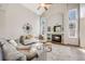 Spacious living room with a stone fireplace, high ceilings, and modern decor at 11223 Jansen St, Parker, CO 80134