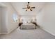 Neutral primary bedroom features a ceiling fan, plush carpet and side table lamps at 11223 Jansen St, Parker, CO 80134