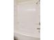 A pristine bathtub with a showerhead and a built-in shelf at 17053 E Tennessee Dr # 101, Aurora, CO 80017