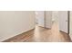 Bedroom featuring hardwood floors and doors to the bathroom and walk-in closet at 17053 E Tennessee Dr # 101, Aurora, CO 80017