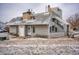 Exterior view of a gray two-story house with a snowy lawn at 17053 E Tennessee Dr # 101, Aurora, CO 80017