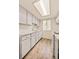 Bright kitchen featuring white cabinets and appliances, complemented by a modern countertop and ample natural light at 17053 E Tennessee Dr # 101, Aurora, CO 80017