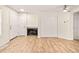 Living room featuring a cozy fireplace, a set of closet doors, and light wood-look floors at 17053 E Tennessee Dr # 101, Aurora, CO 80017