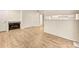 Living room featuring light wood floors, a fireplace, and white walls, creating a cozy and inviting atmosphere at 17053 E Tennessee Dr # 101, Aurora, CO 80017