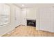 Living room featuring a cozy fireplace, a set of closet doors, and light wood-look floors at 17053 E Tennessee Dr # 101, Aurora, CO 80017