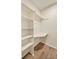 Bright walk-in closet features built-in shelving, providing ample storage space at 17053 E Tennessee Dr # 101, Aurora, CO 80017