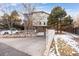 Exterior view of a townhouse with attached garage and snowy landscaping at 6405 S Dayton St # 105, Englewood, CO 80111