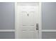 White front door with updated hardware at 6405 S Dayton St # 105, Englewood, CO 80111