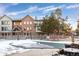 Community pool with winter cover, surrounded by a fenced yard at 6405 S Dayton St # 105, Englewood, CO 80111