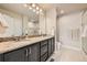 Bathroom featuring granite countertop with double sinks, tile floor and a glass-enclosed shower at 1817 S Buchanan Cir, Aurora, CO 80018