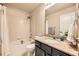 Bathroom with a shower-tub combo with neutral tile and decorative brown granite sink at 1817 S Buchanan Cir, Aurora, CO 80018
