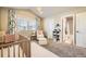 Bright Bedroom with modern crib, a white chair and ottoman, and stylish window treatments at 1817 S Buchanan Cir, Aurora, CO 80018