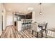 Charming kitchen/dining space with dark cabinets and a breakfast bar, and updated flooring at 1817 S Buchanan Cir, Aurora, CO 80018