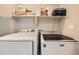 Laundry room featuring side-by-side Samsung and Maytag washer and dryer at 1817 S Buchanan Cir, Aurora, CO 80018