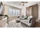 Cozy living room with large windows, a comfortable gray sectional, and stylish decor at 1817 S Buchanan Cir, Aurora, CO 80018