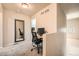 Cozy office space with desk, chair, and mirror, perfect for remote work or study at 1817 S Buchanan Cir, Aurora, CO 80018
