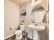 Elegant half bathroom with a pedestal sink and wood-look floors at 1817 S Buchanan Cir, Aurora, CO 80018