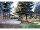Beautiful backyard with lush lawn, brick accents, and mature trees provides a private and serene setting at 1 Winged Foot Way, Littleton, CO 80123