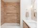 Bathroom showcasing a tub and shower combination with peach-toned tile and modern fixtures at 1 Winged Foot Way, Littleton, CO 80123