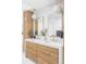 Bathroom featuring a double vanity with stylish light fixtures, gold hardware, and plenty of storage at 1 Winged Foot Way, Littleton, CO 80123