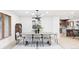 Chic dining room featuring modern light fixture, seating for eight, and contemporary decor at 1 Winged Foot Way, Littleton, CO 80123
